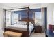Elegantly furnished main bedroom with a four-poster bed and natural lighting at 6219 Voyagers Pl, Apollo Beach, FL 33572