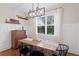 Charming dining area with a rustic table, modern light fixture, and a view of the backyard at 6219 Voyagers Pl, Apollo Beach, FL 33572