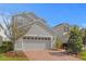 Charming two-story home with a gray exterior, a spacious driveway, and well-maintained landscaping at 6219 Voyagers Pl, Apollo Beach, FL 33572