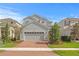Charming two-story home with a gray exterior, a spacious driveway, and well-maintained landscaping at 6219 Voyagers Pl, Apollo Beach, FL 33572