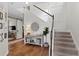 Bright foyer with staircase, hardwood floors, and stylish decor, enhanced by modern wall paneling at 6219 Voyagers Pl, Apollo Beach, FL 33572