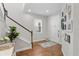 Inviting foyer with hardwood floors, a staircase, and elegant decor creating a warm welcome at 6219 Voyagers Pl, Apollo Beach, FL 33572