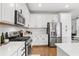 Stylish kitchen features white cabinetry, stainless steel appliances, and modern tile backsplash at 6219 Voyagers Pl, Apollo Beach, FL 33572