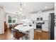 Modern kitchen with stainless steel appliances, a center island, and a dining area at 6219 Voyagers Pl, Apollo Beach, FL 33572