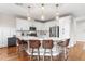Bright kitchen featuring a large island with bar seating, white cabinetry, and stainless steel appliances at 6219 Voyagers Pl, Apollo Beach, FL 33572