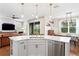 Bright, modern kitchen with white cabinets, a marble countertop island, and stainless steel appliances at 6219 Voyagers Pl, Apollo Beach, FL 33572