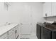 Bright and functional laundry room with modern appliances, cabinets, and a sink at 6219 Voyagers Pl, Apollo Beach, FL 33572