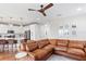 Spacious living area featuring a modern kitchen, comfortable seating, and a unique ceiling fan at 6219 Voyagers Pl, Apollo Beach, FL 33572