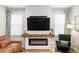Cozy living room featuring a modern fireplace, large television, and comfortable seating at 6219 Voyagers Pl, Apollo Beach, FL 33572