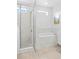 Bright main bathroom featuring a separate tub and shower with tile surround and white cabinetry at 6219 Voyagers Pl, Apollo Beach, FL 33572