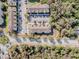 Aerial view showcases the community layout, parking, and lush surrounding trees at 6414 Hollydale Pl # 101, Riverview, FL 33578
