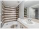 Bathroom featuring a walk-in shower with decorative tile and a vanity with ample counter space at 6414 Hollydale Pl # 101, Riverview, FL 33578