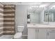 Bathroom featuring a vanity with a sink and a shower with modern, tiled walls at 6414 Hollydale Pl # 101, Riverview, FL 33578