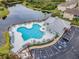 Aerial shot shows the community pool with parking and guest seating along the lake at 6414 Hollydale Pl # 101, Riverview, FL 33578