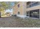 Beige two-story exterior featuring a screened in patio and A/C units, and white trim and accents at 6414 Hollydale Pl # 101, Riverview, FL 33578