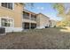 Beige two-story exterior featuring a screened in patio and A/C units, and white trim and accents at 6414 Hollydale Pl # 101, Riverview, FL 33578