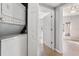 Laundry area with a stackable washer and dryer setup, located near additional living spaces at 6414 Hollydale Pl # 101, Riverview, FL 33578