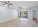 Spacious living room with tile flooring, ceiling fans, and sliding glass doors to the outside at 6414 Hollydale Pl # 101, Riverview, FL 33578