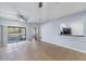 Open living room with tile floors, ceiling fans, and sliding doors to the outdoor patio at 6414 Hollydale Pl # 101, Riverview, FL 33578