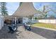 Inviting backyard featuring a shaded patio area with Adirondack chairs and an above-ground pool at 701 63Rd S St, Gulfport, FL 33707