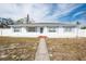 Charming single-story home with white siding, blue shutters, and well-maintained landscaping at 701 63Rd S St, Gulfport, FL 33707