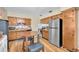 Cozy kitchen featuring wood cabinetry, stainless steel appliances, and a dining area at 701 63Rd S St, Gulfport, FL 33707