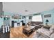 Comfortable living room featuring a large TV, plush sofas, and stylish decor at 701 63Rd S St, Gulfport, FL 33707