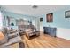 Cozy living room with hardwood floors, a plush sofa, and ample natural light at 701 63Rd S St, Gulfport, FL 33707