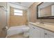 Bathroom with tiled shower over tub, new toilet and vanity at 7507 Betula Dr, New Port Richey, FL 34653