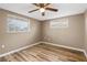 Comfortable bedroom with wood flooring, neutral walls, and natural light at 7507 Betula Dr, New Port Richey, FL 34653