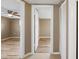 Hallway leading to living room and bedroom, featuring storage at 7507 Betula Dr, New Port Richey, FL 34653