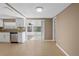Dining area adjacent to a kitchen with stainless steel appliances and sliding glass doors to patio at 7507 Betula Dr, New Port Richey, FL 34653