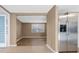 Open living room view with stainless steel refrigerator and tile and wood flooring at 7507 Betula Dr, New Port Richey, FL 34653