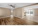 Open-concept living room with wood floors leading to the kitchen at 7507 Betula Dr, New Port Richey, FL 34653