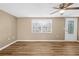 Living room with stylish vinyl flooring, a ceiling fan, and a bright window at 7507 Betula Dr, New Port Richey, FL 34653