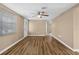 Bright living room with wood flooring, ceiling fan, and natural light at 7507 Betula Dr, New Port Richey, FL 34653