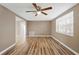 Inviting living room featuring wood floors, ceiling fan, and ample natural light at 7507 Betula Dr, New Port Richey, FL 34653