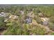 Aerial view of a home surrounded by lush trees and a private backyard with pool at 7546 Richland St, Wesley Chapel, FL 33544