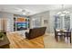 Open living room featuring hardwood floors, built-in shelving, and a view of the pool at 7546 Richland St, Wesley Chapel, FL 33544