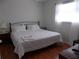 Relaxing bedroom with a comfortable bed, bedside table, and natural light from the window at 7729 39Th N Ter, St Petersburg, FL 33709