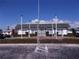 Low-rise community building with green roof, surrounded by trimmed hedges and palm trees at 7729 39Th N Ter, St Petersburg, FL 33709