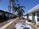 Charming community featuring well-maintained walkways, palm trees, and inviting outdoor seating areas for relaxation at 7729 39Th N Ter, St Petersburg, FL 33709