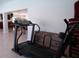 Treadmill in the fitness room with open view to the common area and seating at 7729 39Th N Ter, St Petersburg, FL 33709
