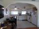 Bright kitchen featuring white cabinetry, a dining table, and modern appliances, perfect for cooking and entertaining at 7729 39Th N Ter, St Petersburg, FL 33709