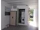 Laundry closet with stacked washer and dryer, located in carport storage area at 7729 39Th N Ter, St Petersburg, FL 33709