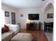 Inviting living room with a comfortable couch and ottoman, a dedicated desk space, and a wall-mounted TV at 7729 39Th N Ter, St Petersburg, FL 33709