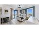 Bright bedroom with sliding glass doors, stylish furniture, and water views at 774 Gran Kaymen Way, Apollo Beach, FL 33572