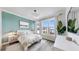 Cozy bedroom featuring neutral decor, large windows, and a stylish accent wall at 774 Gran Kaymen Way, Apollo Beach, FL 33572