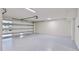 Spacious garage with epoxy floor, storage, and automatic door at 774 Gran Kaymen Way, Apollo Beach, FL 33572
