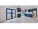 Spacious kitchen with blue cabinets, marble countertops, stainless appliances and a water view at 774 Gran Kaymen Way, Apollo Beach, FL 33572